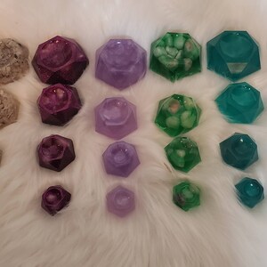 May include: A set of 30 small, geometric resin trinket dishes in various colors, including pink, white, purple, green, and brown. Each dish has a different design and features a variety of inclusions, such as glitter, shells, and stones.
