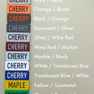 May include: Colour examples for cherry and mesquite wood finishes. The cherry wood finishes are shown in grey, orange, black, gunmetal, silver, wine red, marble, white, and translucent blue. The mesquite wood finishes are shown in yellow, green, and green. Each colour combination is labelled with the two colours used.