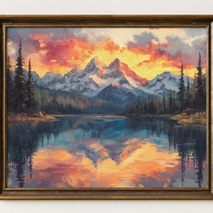 May include: Oil painting of a mountain landscape with a lake, framed in a gold-toned wooden frame. The artwork depicts snow-capped mountains under a vibrant sunset sky, with the lake reflecting the colorful clouds and mountains.