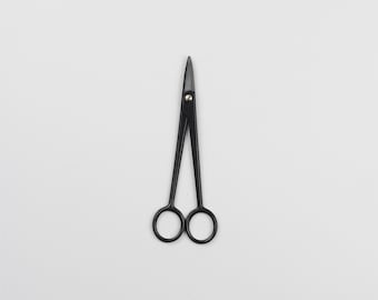 May include: Black metal scissors with rounded tips.