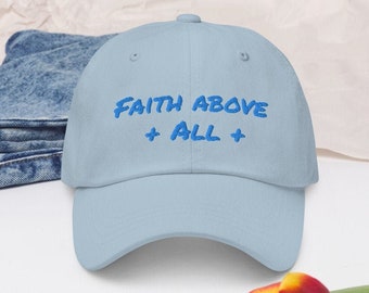 May include: A light blue baseball cap with the text "FAITH ABOVE ALL" embroidered in blue.