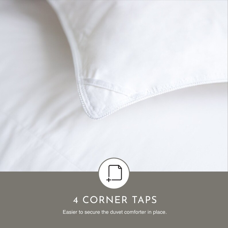 May include: Close-up of a white duvet cover with four corner tabs. The text "4 CORNER TAPS" is written in black below the image. The text "Easier to secure the duvet comforter in place." is written in black below the text "4 CORNER TAPS".