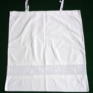 May include: White cotton pillowcase with a crocheted lace trim and embroidered initials "S.C."