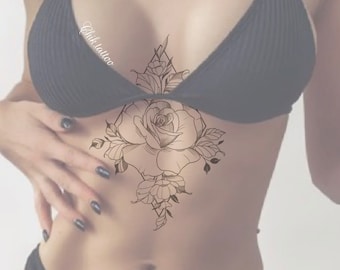 May include: A black and white line drawing tattoo design of a rose with leaves and geometric shapes. The tattoo is on a person's chest.