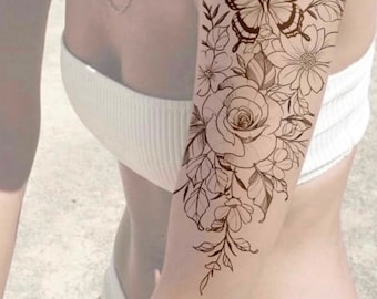 May include: A black and white line drawing tattoo design of a rose, butterfly, and leaves. The tattoo design is on a person's arm.