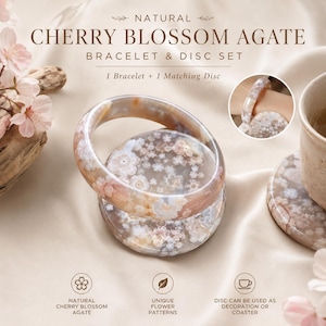 May include: A natural cherry blossom agate bracelet and disc set. The smooth, polished stone features translucent pink, white, and brown tones with floral-like inclusions. The set includes one circular bangle bracelet and one matching flat disc.