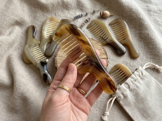 Carved from real ox horn, this anti-static pocket comb is a legitimately ancient material with a tactile quality no plastic comb can match.