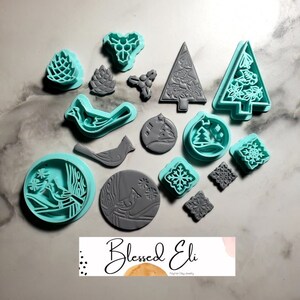 May include: A set of 15 Christmas-themed cookie cutters in teal and gray. The cutters include a bird, a pine cone, a snowflake, a Christmas tree, and a holly berry.