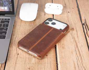 May include: A brown leather smartphone case with a vertical stitched seam down the center, featuring a cutout for a triple-lens camera system. The case has a smooth, matte texture and covers the back and sides of the mobile device completely.
