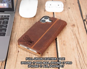 May include: A brown leather phone case with a dragonfly design. The case is for an iPhone 17 Pro Max, iPhone 17 Pro, iPhone 17 Air, and iPhone 17. The case is on a wooden surface with a laptop, mouse, and earbuds.