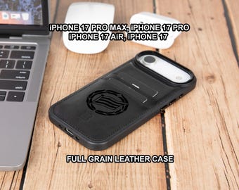 May include: Black full-grain leather phone case with a decorative emblem. The case is designed for iPhone 17 Pro Max, Pro, Air, and 17 models. The case has slots for cards and a camera cutout. The text "FULL GRAIN LEATHER CASE" is visible.