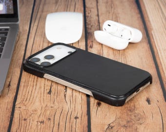 May include: A black smartphone case with a textured finish and a raised camera cutout, featuring a slim profile that exposes the metallic side buttons of the device. The case is designed to fit a phone with a triple-lens camera system.
