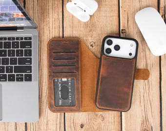 May include: A brown leather wallet-style phone case with a detachable magnetic back cover. The interior features multiple card slots and a clear ID window. The exterior back cover holds a smartphone with a triple-lens camera system.