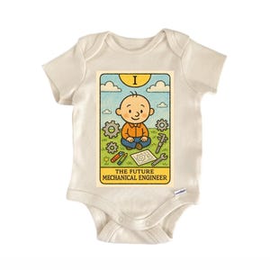 May include: Cream baby bodysuit with a cartoon graphic. The graphic shows a smiling baby with engineering tools and the text "THE FUTURE MECHANICAL ENGINEER". The design includes gears, a wrench, and a blueprint.