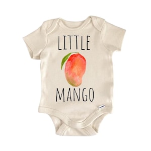 May include: Cream-colored baby onesie with the words "LITTLE MANGO" in black block letters. A watercolor-style mango illustration in red, orange, and green is centered below the word "LITTLE". The onesie has short sleeves and snaps at the bottom.