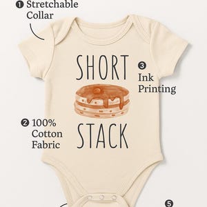 a baby onesie with a short neckline and a stretchable collar. The short stack fabric is 100% cotton, and the short stack is easy to snap closure. The short stack also has reinforced stitching for durability.