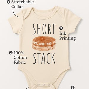 a baby onesie with a short neckline and a stretchable collar. The short stack fabric is 100% cotton, and the short stack is easy to snap closure. The short stack also has reinforced stitching for durability.
