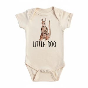 May include: Cream-colored baby bodysuit with a watercolor illustration of a kangaroo and joey. The text "LITTLE ROO" is printed in black below the kangaroo. The bodysuit has short sleeves and snap closures.