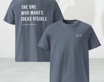 May include: Two blue t-shirts. One shirt has the text "THE ONE WHO MAKES IDEAS VISIBLE" and "EVERYDAY HEROES CO." in white. The other shirt has the letters "EHC" in white. Both shirts are short-sleeved.