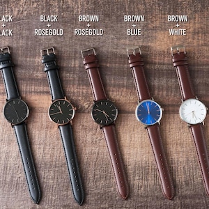 four different styles of watches sitting on a table