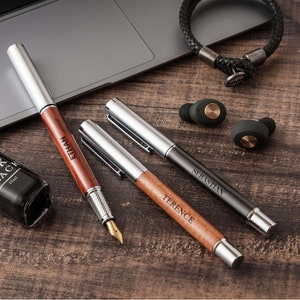 a wooden table topped with a laptop computer