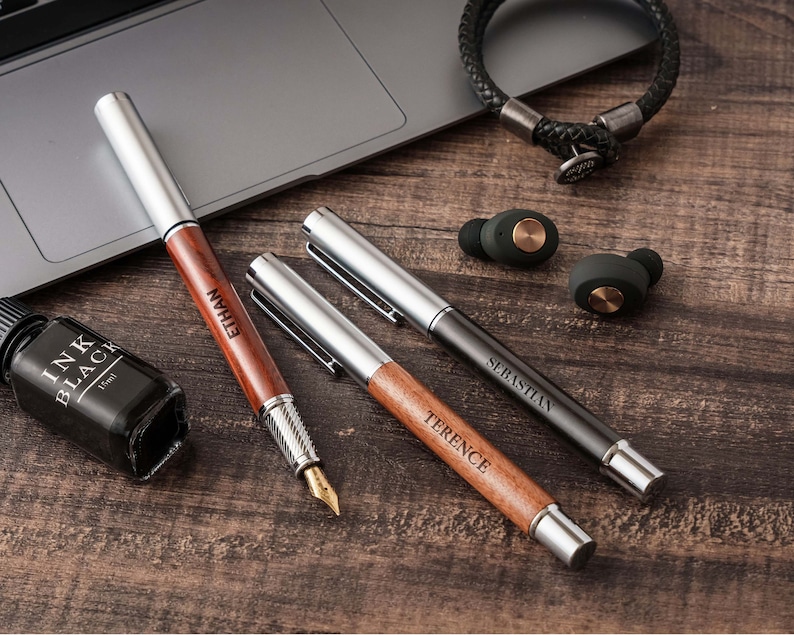 a wooden table topped with a laptop computer