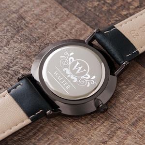 a close up of a watch on a wooden surface