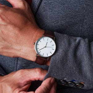 a close up of a person wearing a watch
