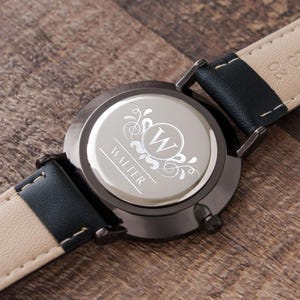 a close up of a watch on a wooden surface