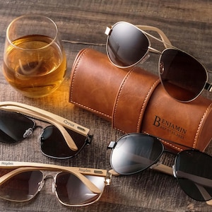 a couple of glasses sitting next to a leather case