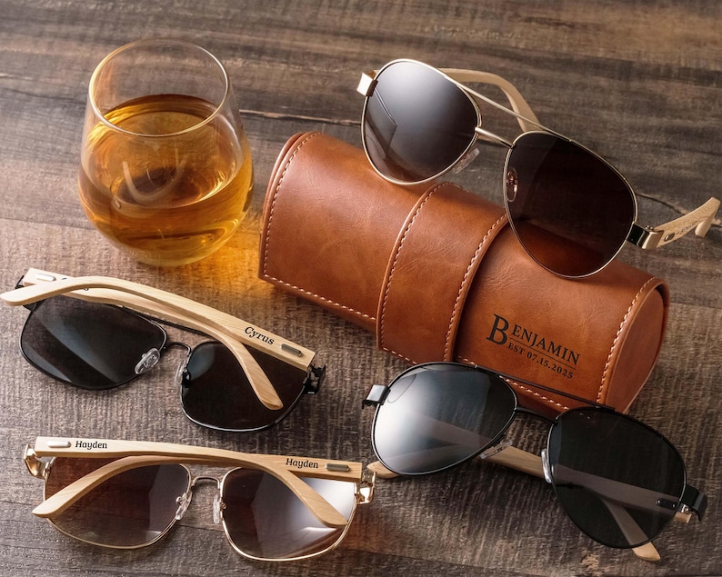 a couple of glasses sitting next to a leather case
