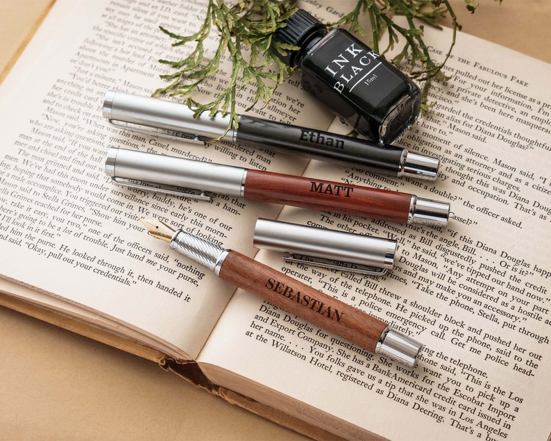 a book with some pens and a bottle on top of it