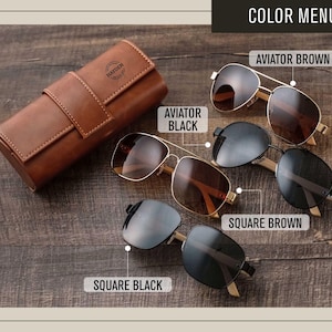 a pair of sunglasses sitting next to a leather case