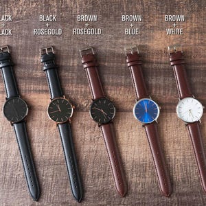 four different styles of watches sitting on a table