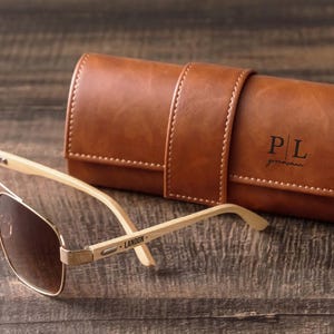 a pair of sunglasses sitting on top of a wooden table