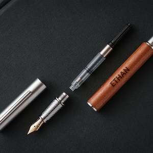 a pen and a lighter on a black surface