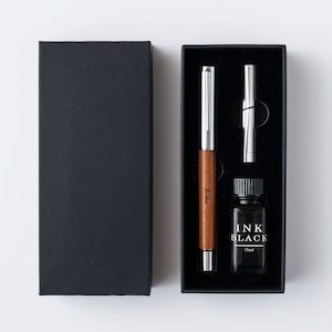 a black box with a pen and a pen in it