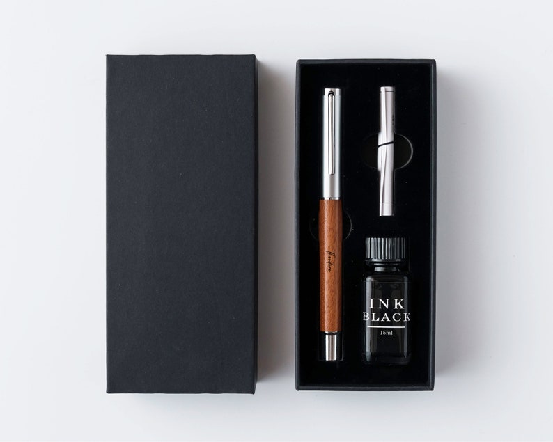 a black box with a pen and a pen in it