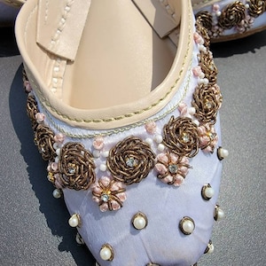 Beautiful white silk base khussa with pearl kora dabka hand work. Pakistani ready to wear.