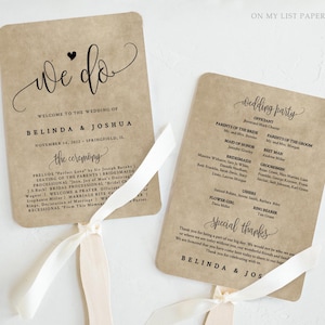 May include: Two kraft paper wedding fans with white ribbon handles. The first fan reads "We do" with the wedding details. The second fan lists the wedding party and special thanks. The text is in black script.