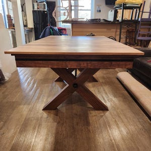 May include: A distressed white wooden sign displaying the word "Welcome" in a handwritten font. The sign has a rustic appearance with a floral design in the corner. Suitable for indoor or outdoor use, it's a charming home decor item.