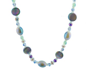 May include: A light green beaded necklace with iridescent oval and round beads. Matching earrings with iridescent beads.