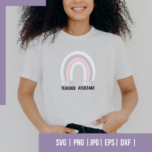 May include: A white t-shirt with a rainbow design and the text "Teacher Assistant".