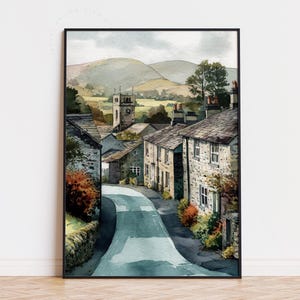 May include: Watercolor print of a quaint village scene. The artwork depicts a winding road leading through stone buildings with a church steeple in the distance. The color palette includes muted greens, blues, and browns, creating a serene and picturesque landscape.