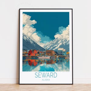 May include: A framed art print of Seward, Alaska, featuring a harbor scene with colorful buildings, boats, and snow-capped mountains under a blue sky. The word "SEWARD" and "ALASKA" are printed at the bottom.