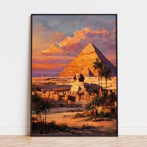 May include: A framed print depicting an Egyptian scene with the Great Pyramid, Sphinx, and palm trees. The artwork uses warm colours like orange, yellow, and red, with a sunset sky. The print is in a black frame, evoking a sense of history and travel.