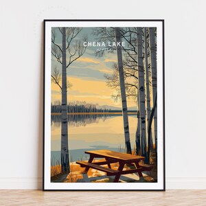 May include: Framed art print featuring a scenic view of Chena Lake, Alaska. The artwork depicts a lake scene with birch trees, a picnic table, and a sunset. The text "CHENA LAKE" is displayed at the top of the print.