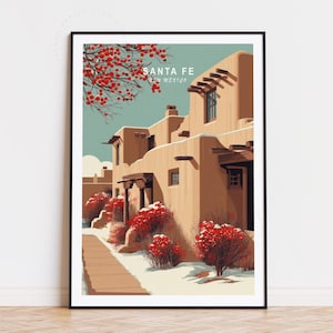 May include: A framed art print featuring a Southwestern adobe building scene in warm earth tones. The print includes the text "Santa Fe, New Mexico" and depicts red flowering bushes and a blue sky.