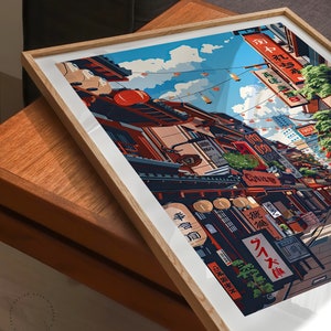 May include: A framed illustration depicting a Japanese street scene with colourful buildings, lanterns, and signs. The street is lined with shops and restaurants, and people are walking around. The sky is blue and there are clouds in the distance.
