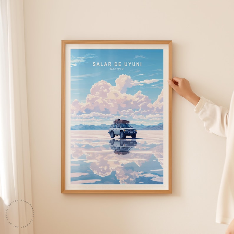 May include: A framed poster with a blue sky and white clouds reflected in a body of water. A white car with a luggage rack drives across the water. The poster has the text "SALAR DE UYUNI" and "BOLIVIA" in smaller text.